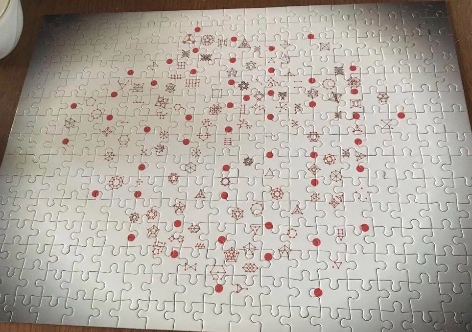 assembled jigsaw puzzle showing dots, lines, big dots