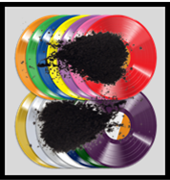 Two rows of various colored vinyl discs, each of which has a pile of black powder on top of them